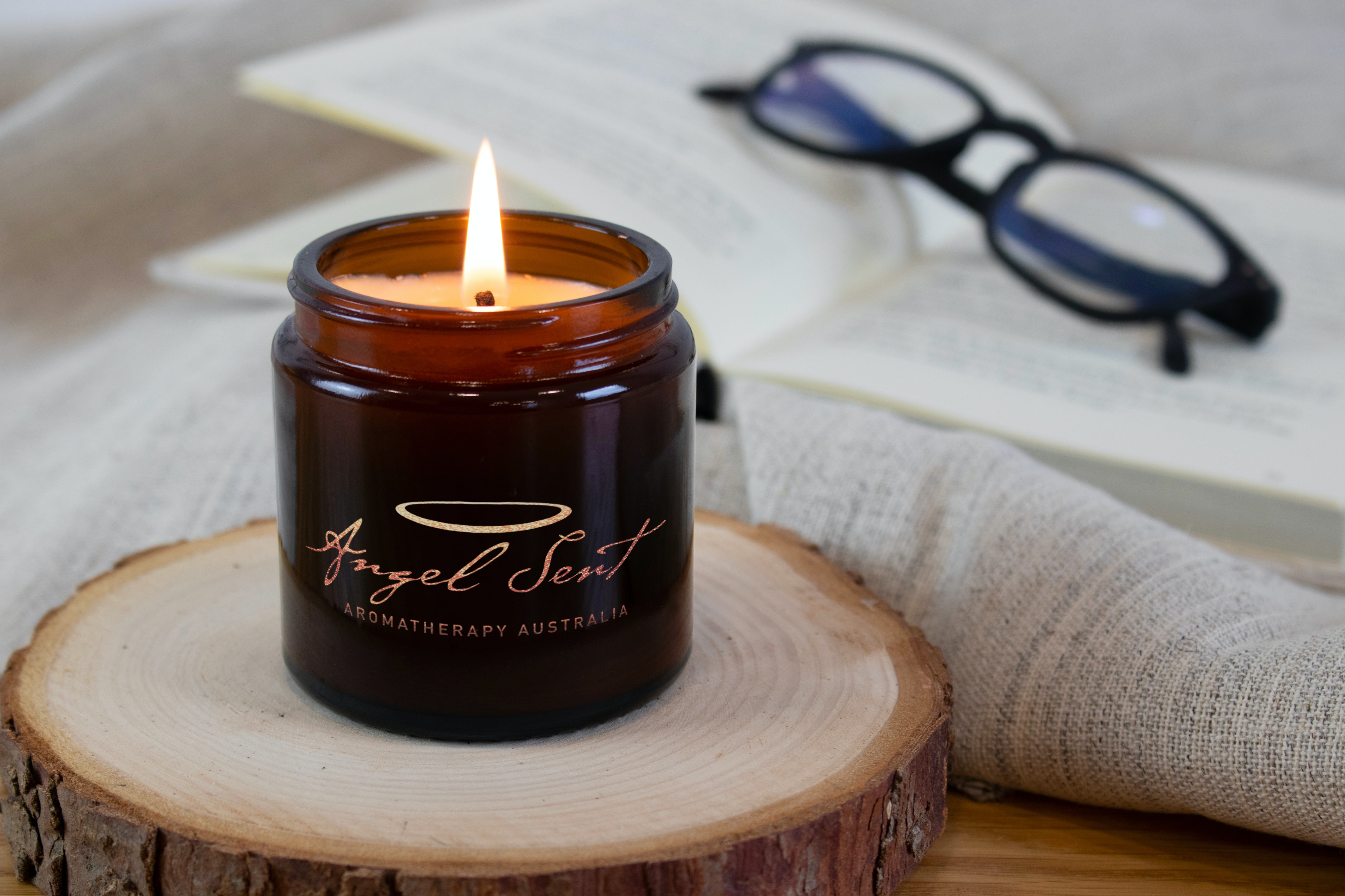 Burning candle near the opened book_Angel Sent Logo-2 Angel Sent Soy Wax Candles Aroma Blend